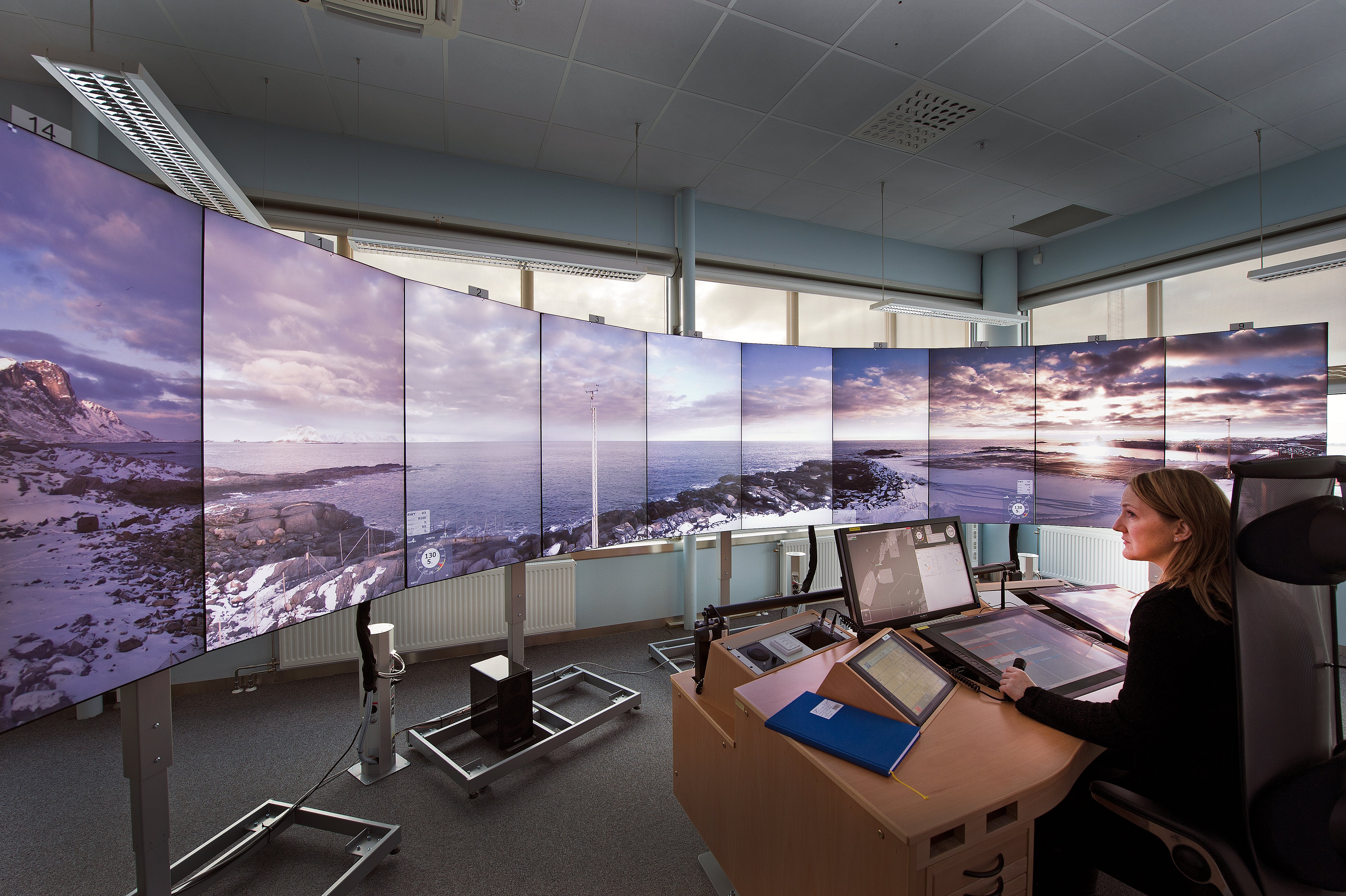 An AFIS officer sits on duty at the RVT screens at Bodø airport.