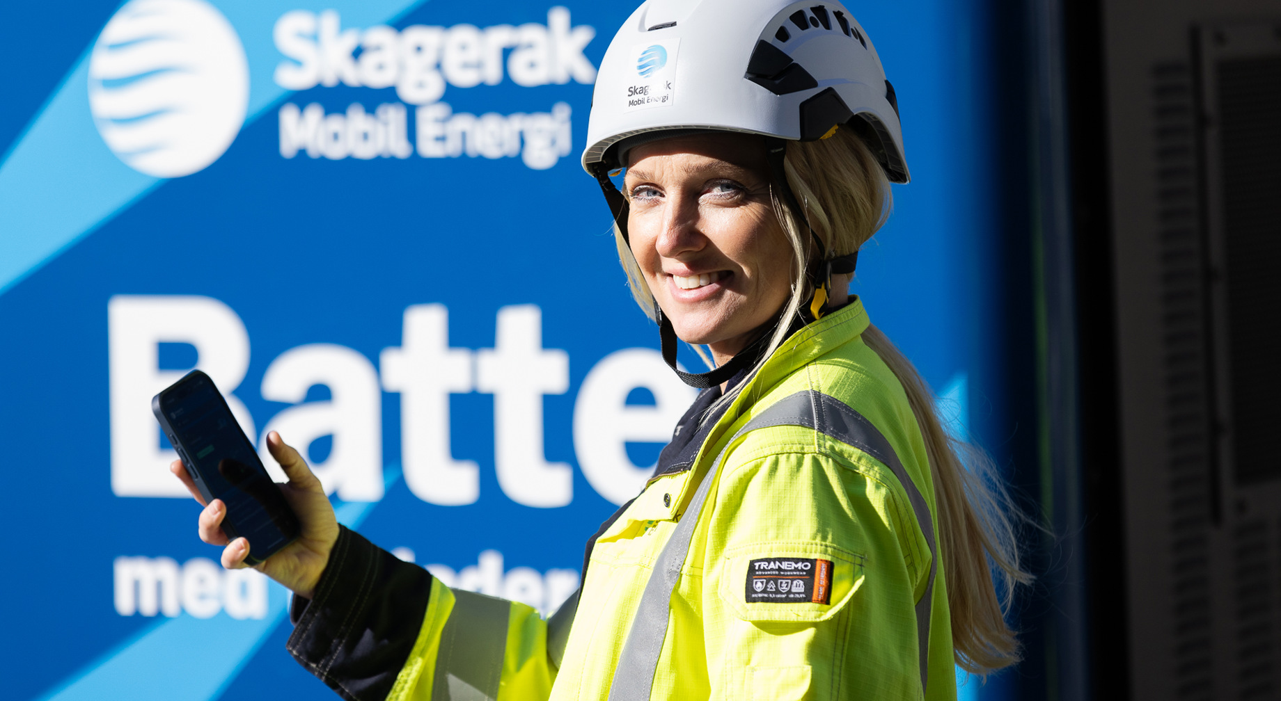 Woman in work uniform holding a mobile phone